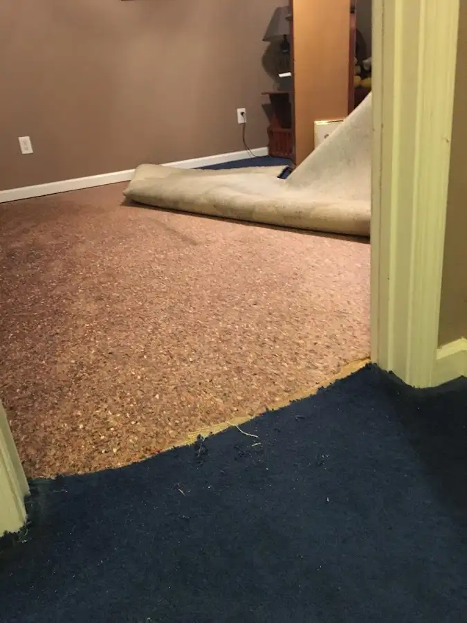 Carpet pad removal revealing water damage during Water Mitigation Services in Folsom
